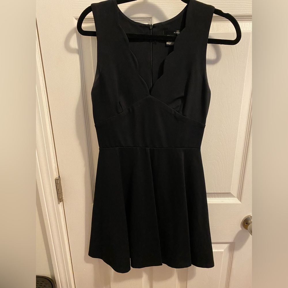 Scalloped neck black dress. Mid thigh length